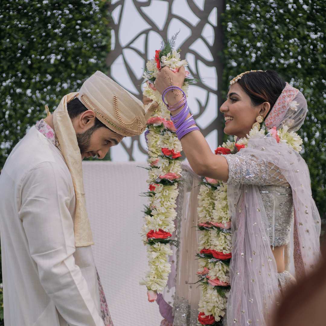 a man and woman holding flowers