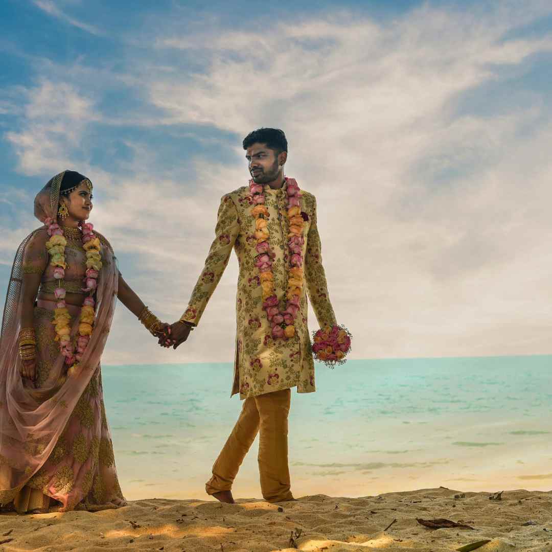 two souls hold hands near sea